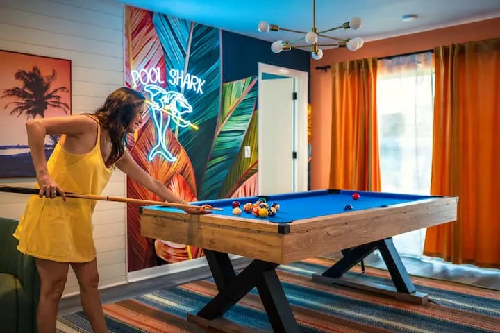 Playing pool under the Pool Shark mural