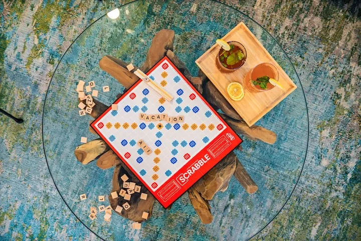 Scrabble board and cocktails on coffee table