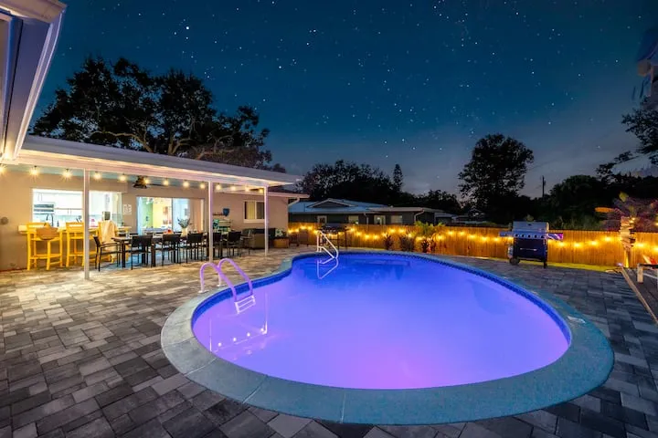 Pool with color-changing LED lights at night