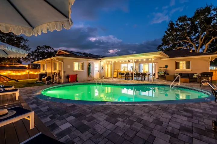 Pool glowing at twilight with string lights