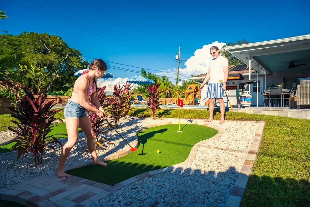 Couple playing mini golf