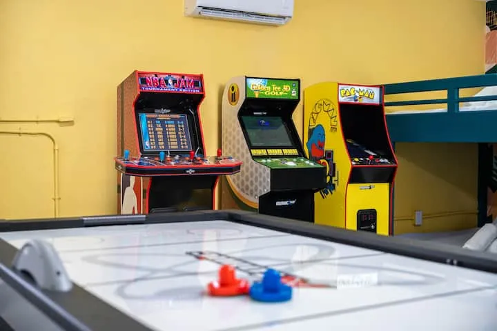 NBA Jam, Golden Tee, and Pac-Man arcade cabinets