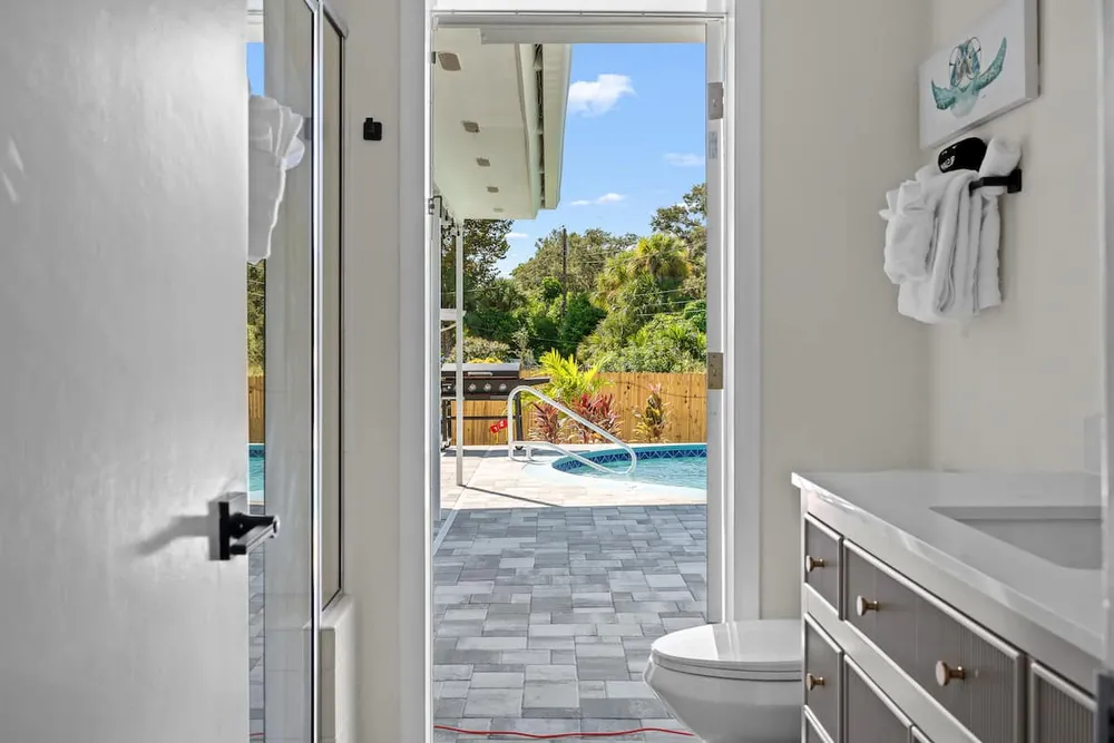 Bathroom 2 with door opening to pool