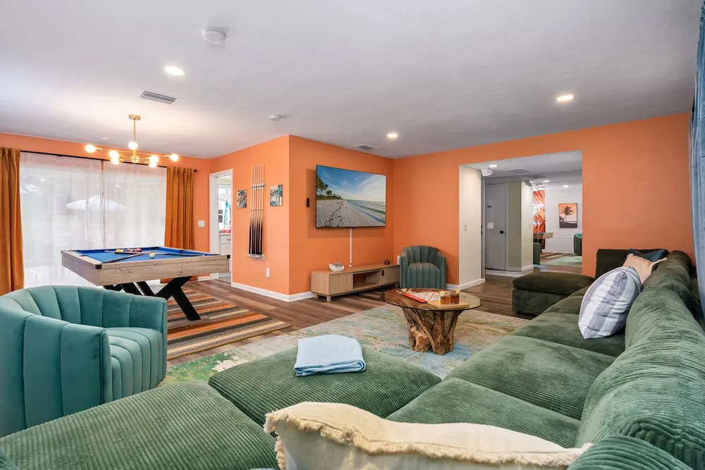 Open living room with pool table and sectional