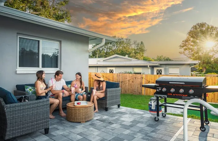 Family lounging on patio with Blackstone grill