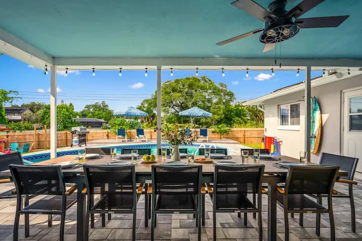 Covered patio with pool view and ceiling fan